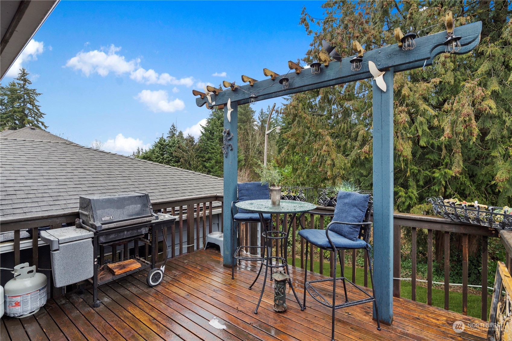 21417 Meridian Drive Southeast Bothell, WA 98021 - Photo 32 of 36 a view of a patio with table and chairs a barbeque with wooden floor and fence
