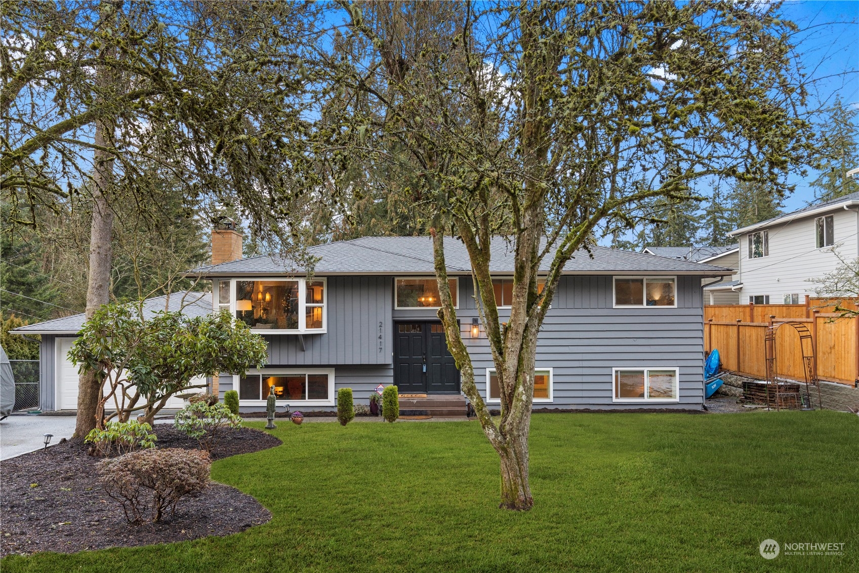21417 Meridian Drive Southeast Bothell, WA 98021 - Photo 4 of 36 a front view of a house with a garden
