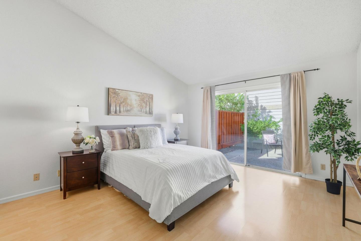 2327 Farmcrest Street Milpitas, CA 95035 - Photo 20 of 36 a bedroom with a large bed and a large window