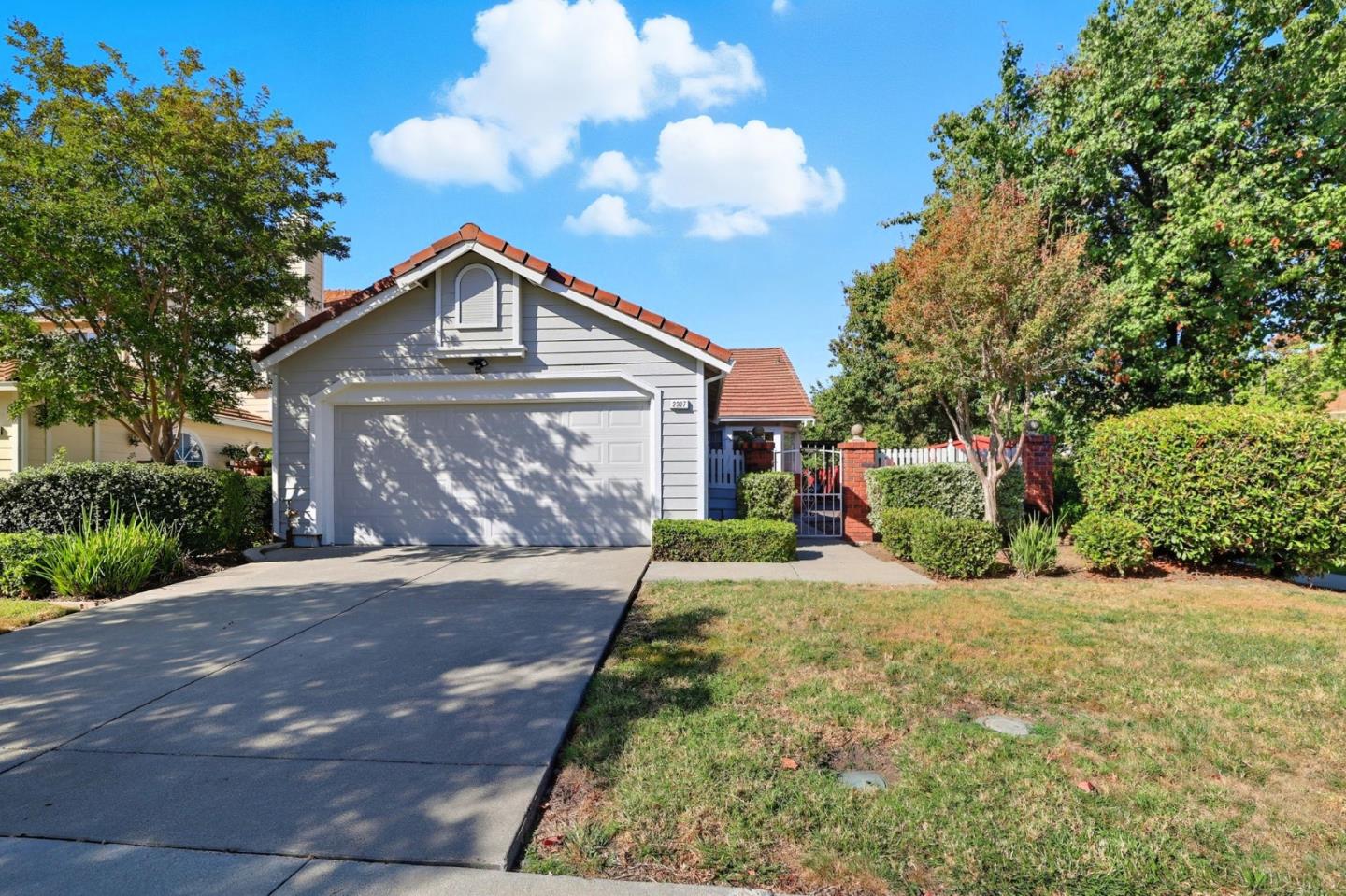 2327 Farmcrest Street Milpitas, CA 95035 - Photo 2 of 36 a front view of a house with a yard and garage