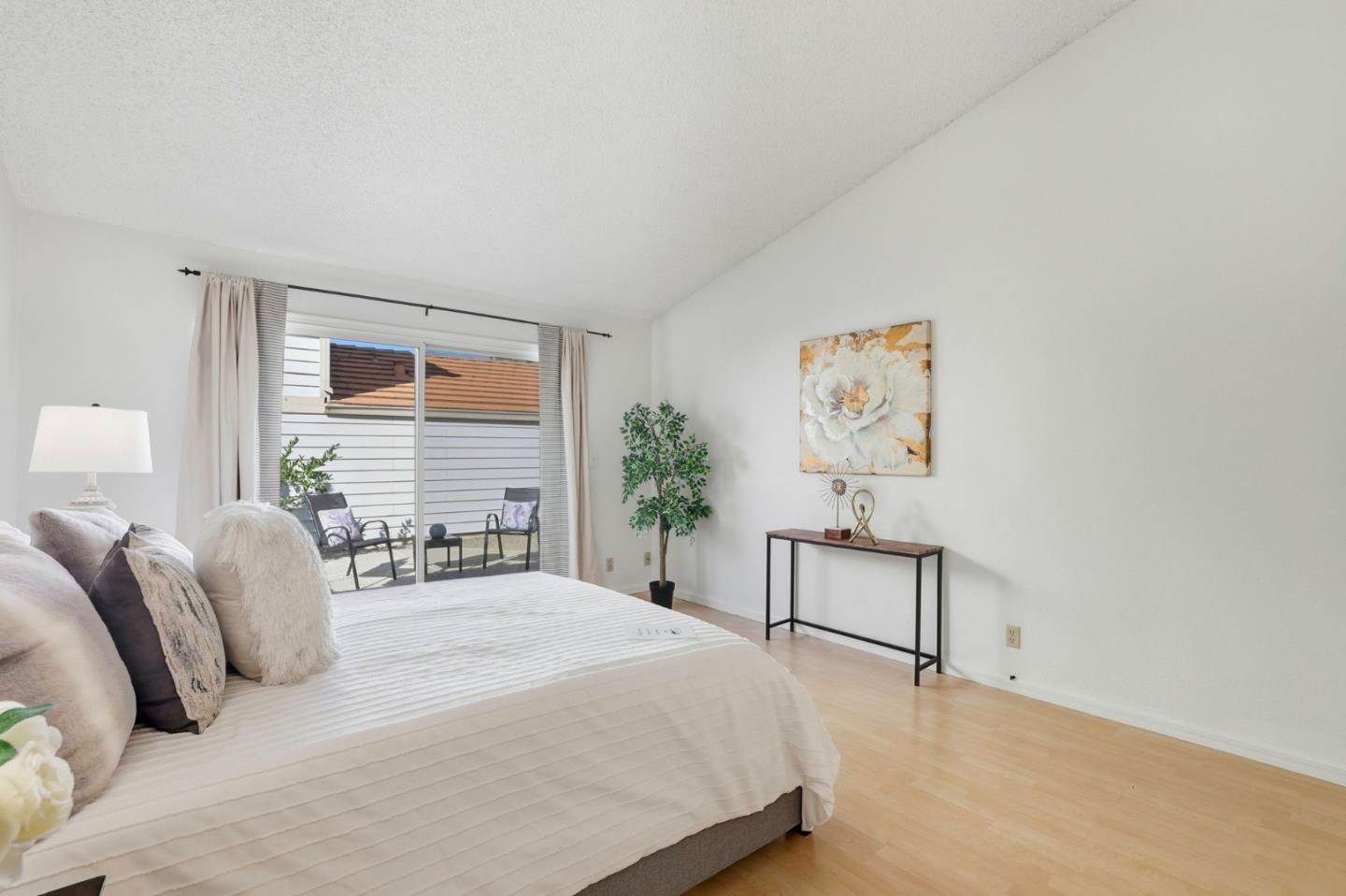 2327 Farmcrest Street Milpitas, CA 95035 - Photo 21 of 36 a bedroom with a bed painting on wall and a potted plant