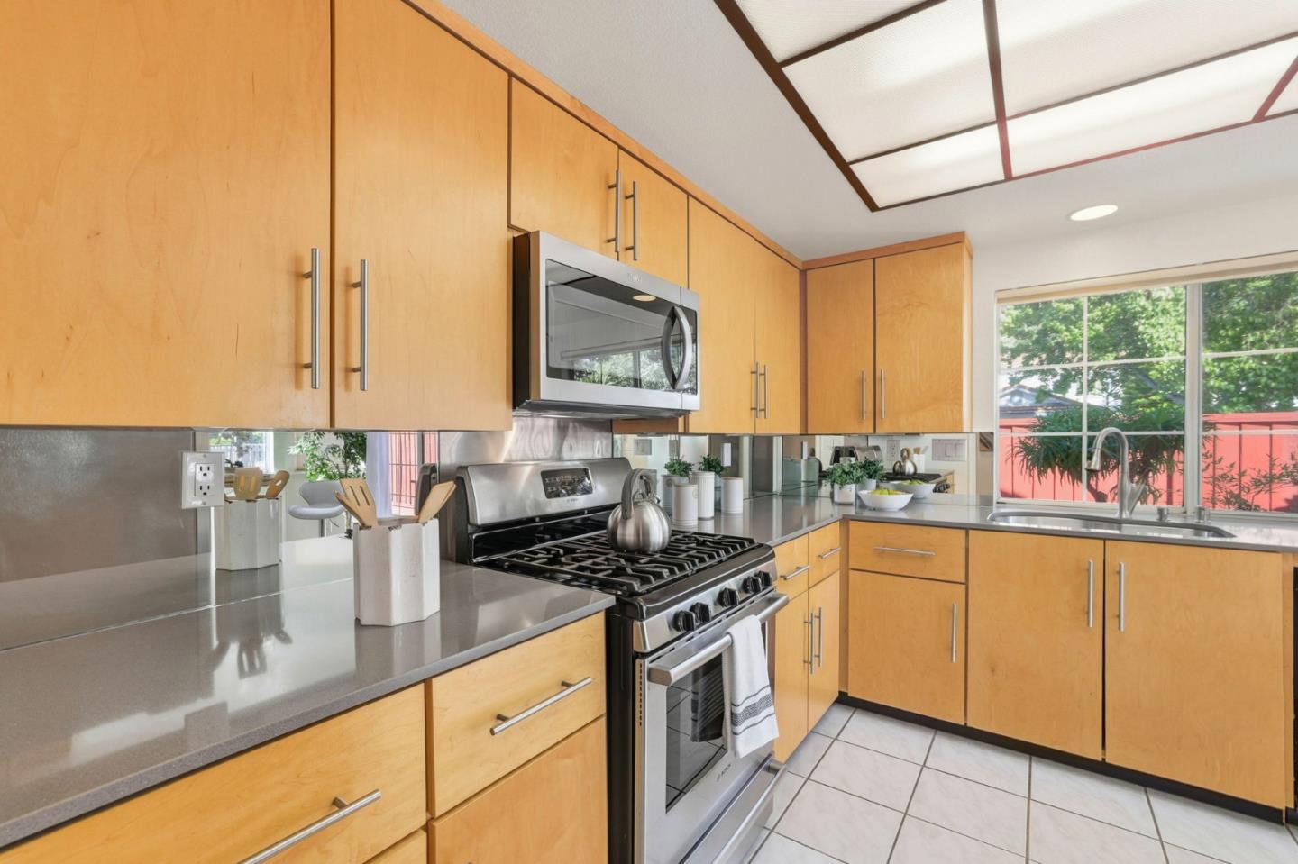 2327 Farmcrest Street Milpitas, CA 95035 - Photo 10 of 36 a kitchen with stainless steel appliances granite countertop a sink stove and cabinets