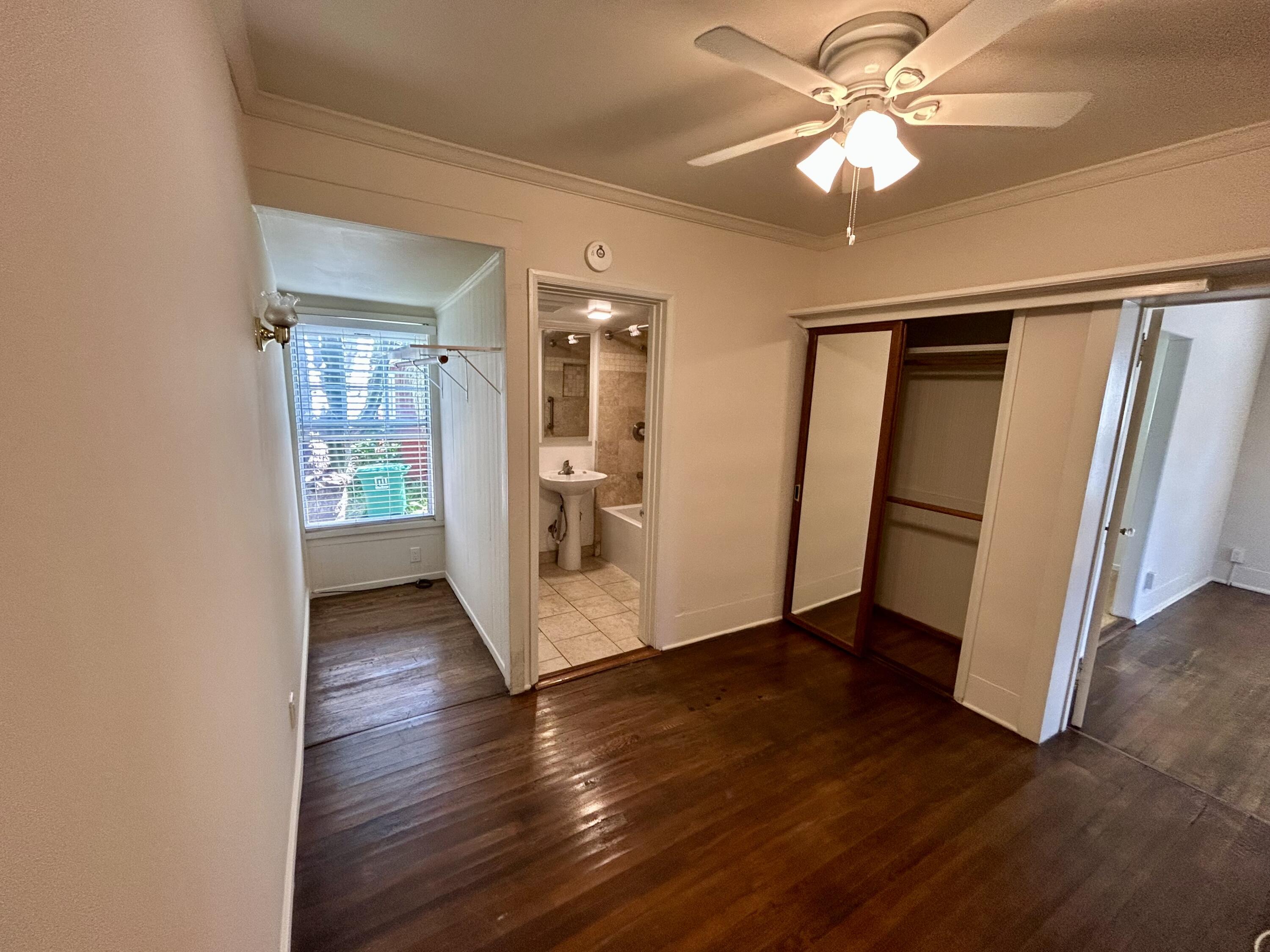 323 West Victoria Street, Unit B Santa Barbara, CA 93101 - Photo 6 of 13 wooden floor in an empty room with a window