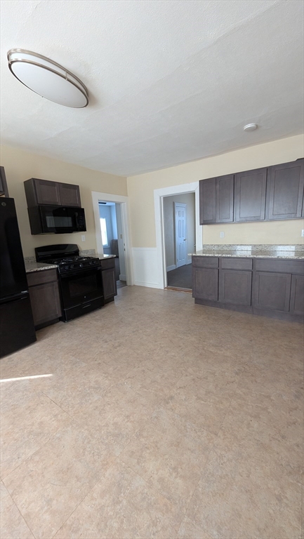 6 Brandon Road, Unit 1 Dudley, MA 01571 - Photo 11 of 14 a large kitchen with a stove top oven a sink and dishwasher