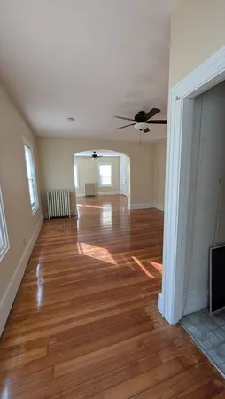 a view of a room with wooden floor