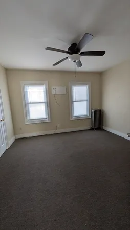 an empty room with a empty space and windows