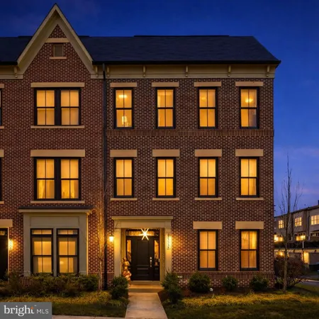 a front view of a residential apartment building with a yard