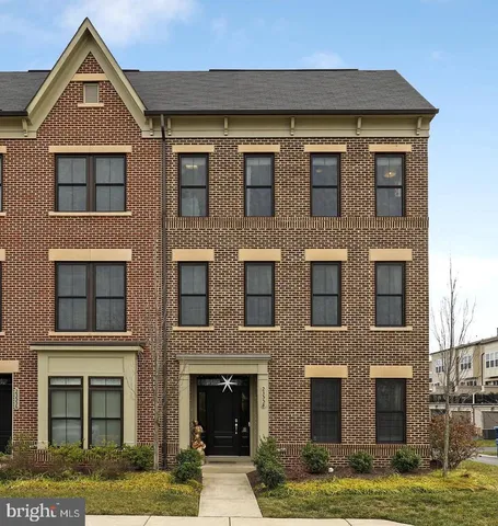a living room with furniture and a book shelf