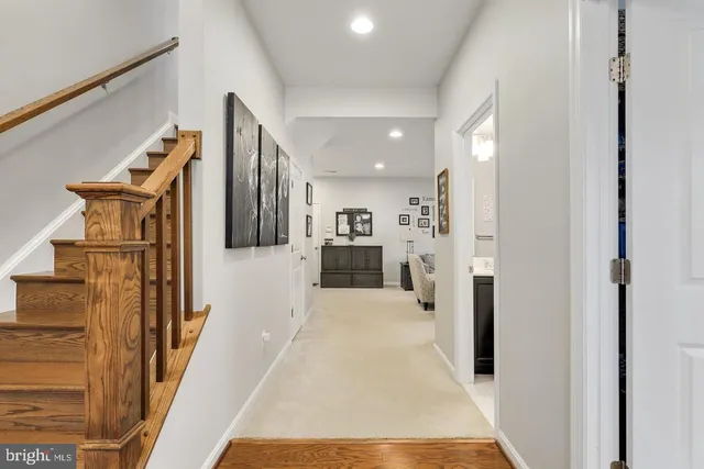 a bedroom with a large bed and a chandelier fan