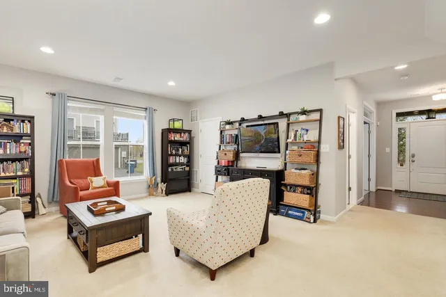 a kitchen with stainless steel appliances kitchen island granite countertop a table chairs sink and cabinets