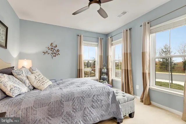 a kitchen with stainless steel appliances a dining table chairs and white cabinets