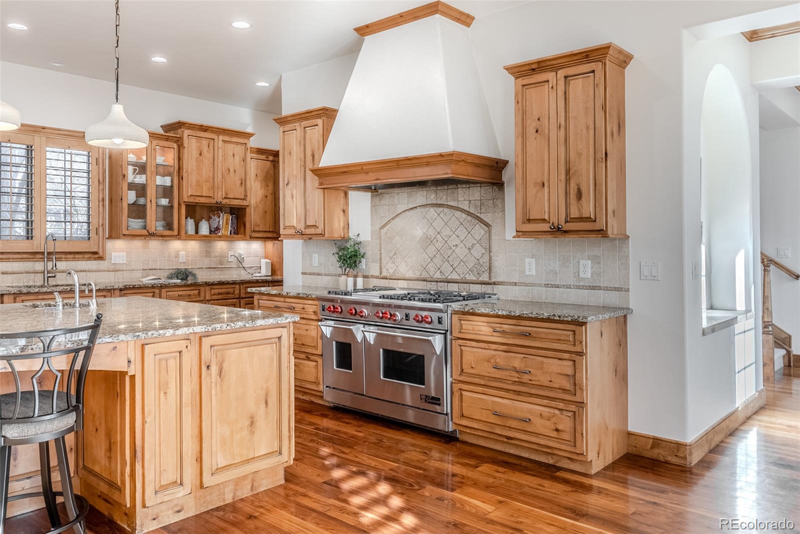 2515 South Fillmore Street Denver, CO 80210 - Photo 14 of 40 a kitchen with stainless steel appliances granite countertop a stove a sink and a refrigerator