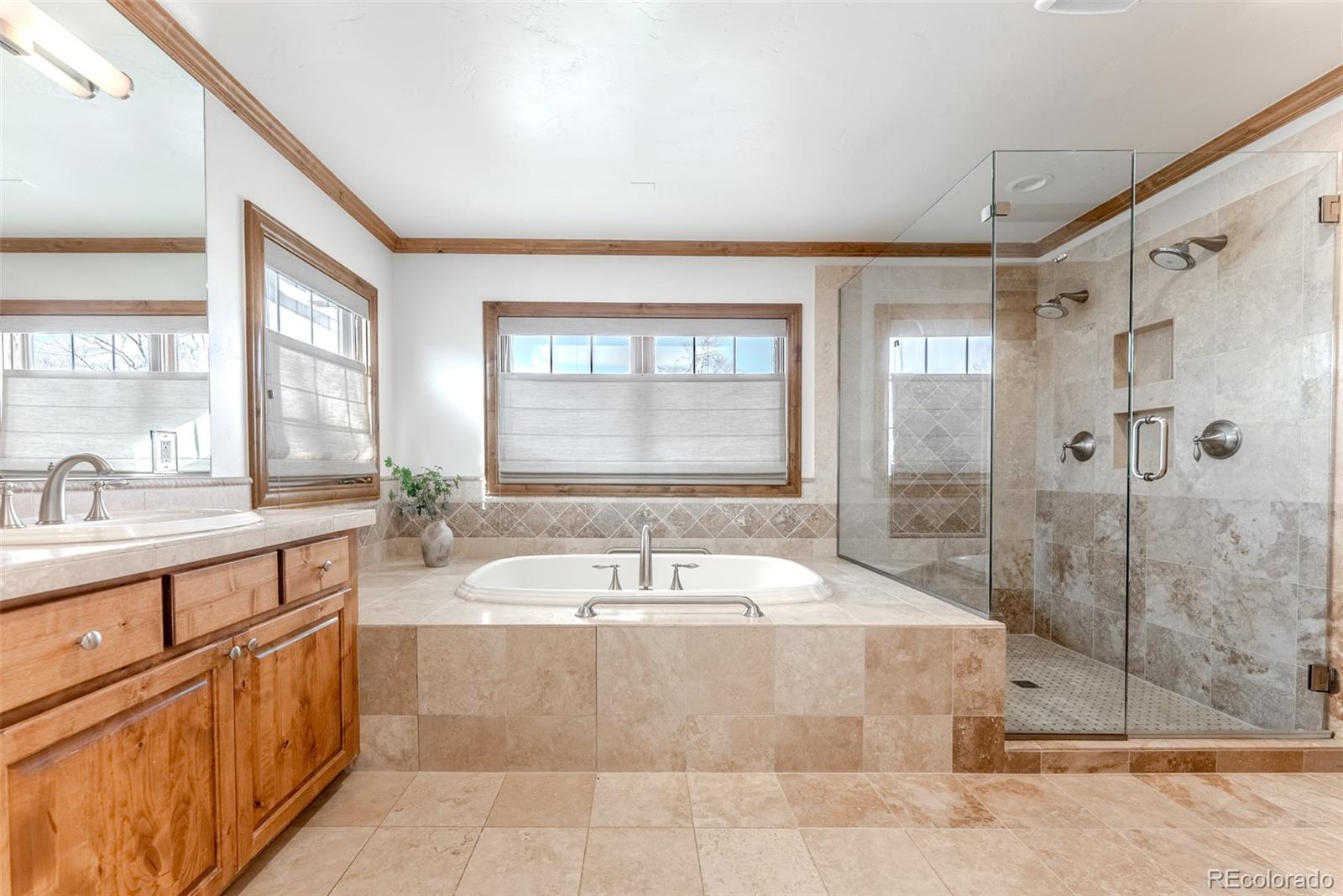 2515 South Fillmore Street Denver, CO 80210 - Photo 22 of 40 a spacious bathroom with a tub sink shower and mirror