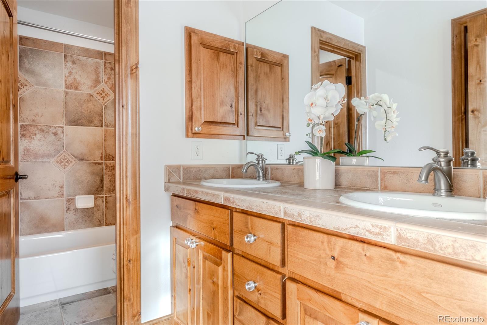 2515 South Fillmore Street Denver, CO 80210 - Photo 28 of 40 a bathroom with a granite countertop sink and a mirror