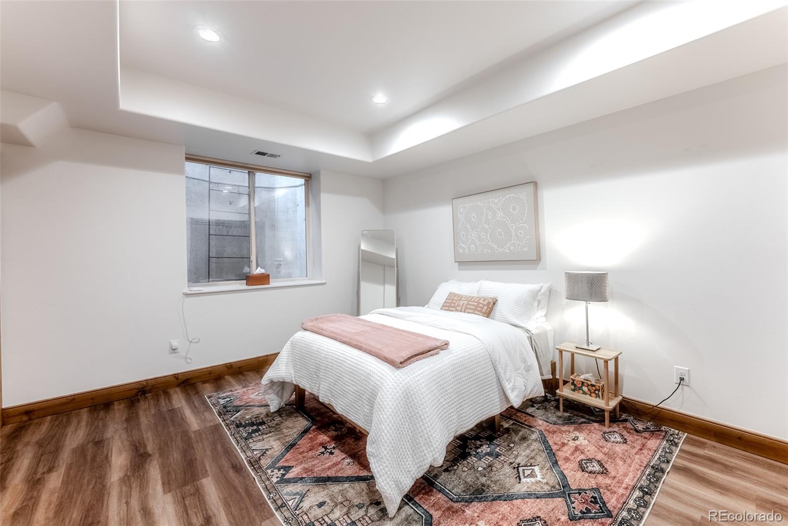 2515 South Fillmore Street Denver, CO 80210 - Photo 29 of 39 a bed room with a bed and a lamp