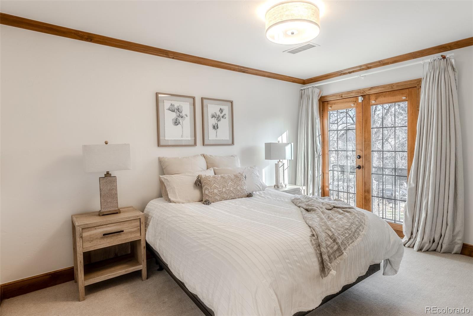 2515 South Fillmore Street Denver, CO 80210 - Photo 29 of 40 a bedroom with a bed and a large window