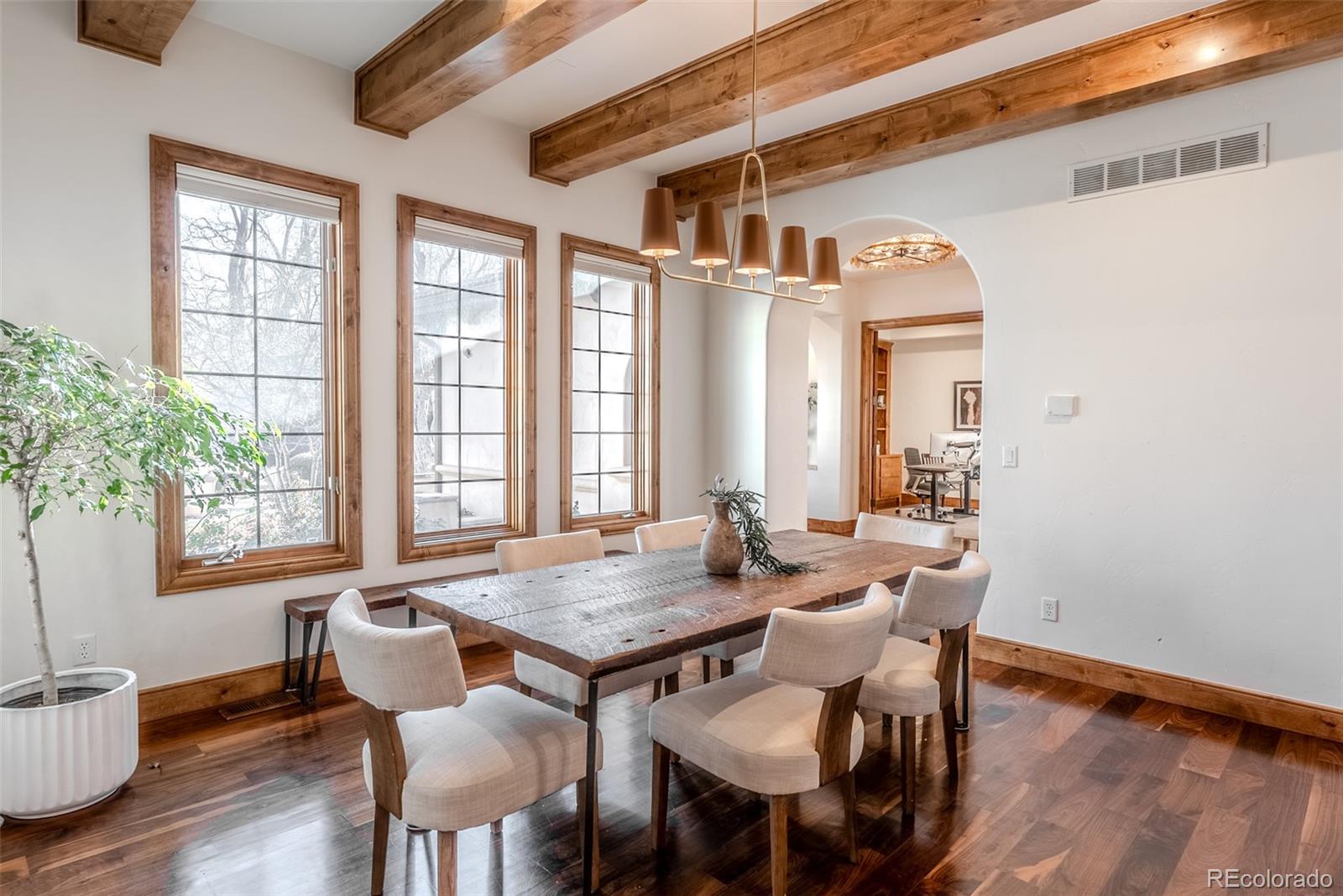 2515 South Fillmore Street Denver, CO 80210 - Photo 9 of 40 a view of a dining room with furniture and wooden floor