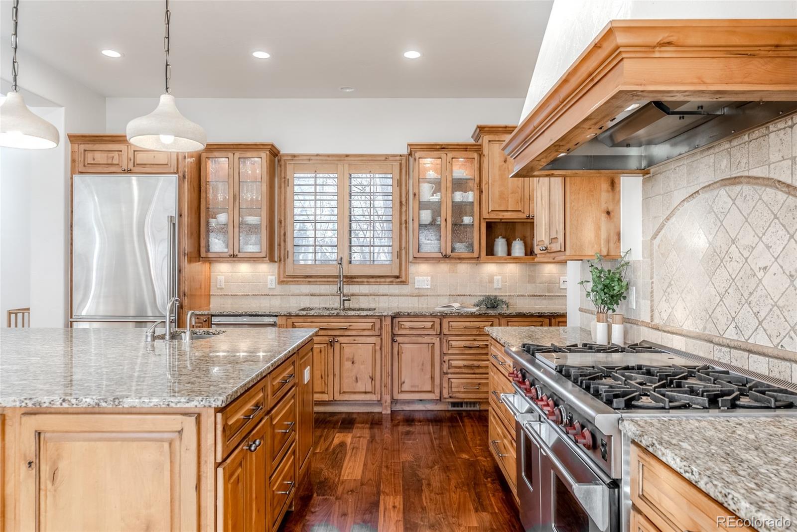 2515 South Fillmore Street Denver, CO 80210 - Photo 9 of 39 a kitchen with a stove a sink and a refrigerator