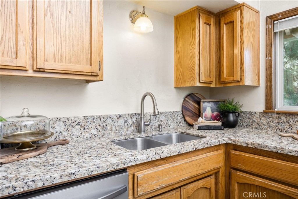 23740 Lakeview Drive Tehachapi, CA 93561 - Photo 15 of 48 a kitchen with granite countertop white cabinets and a sink