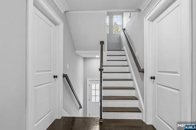 a view of entryway with wooden floor and stairs