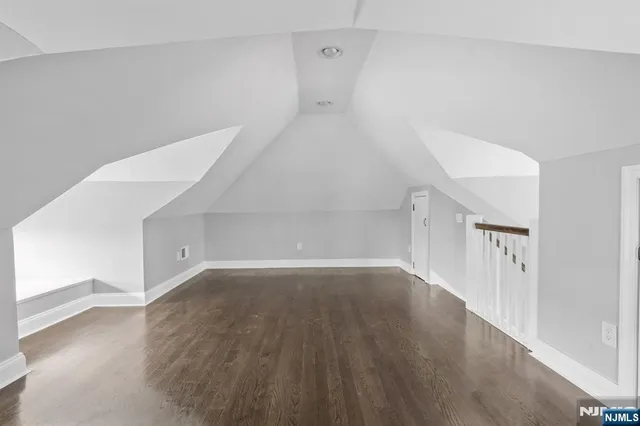 a view of a room with wooden floor and white walls