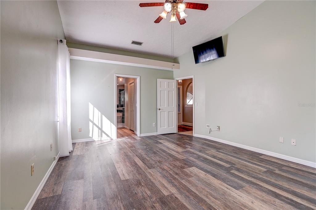 1418 Buckner Road Valrico, FL 33596 - Photo 12 of 37 wooden floor in an empty room with a window