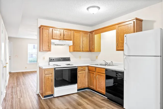 a kitchen with a sink stove and refrigerator