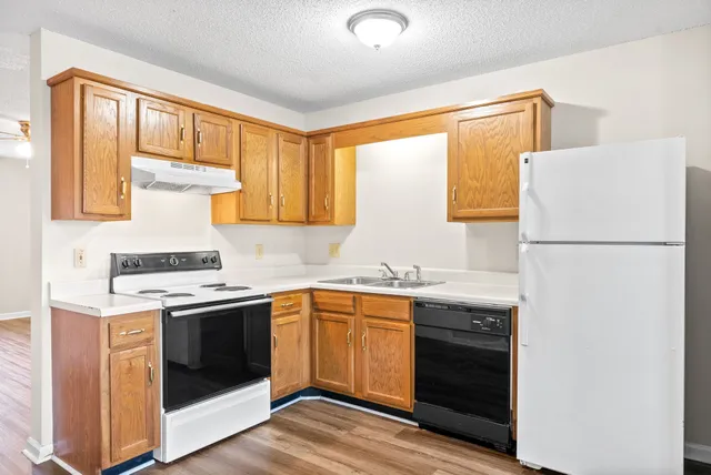 a kitchen with a sink stove and refrigerator