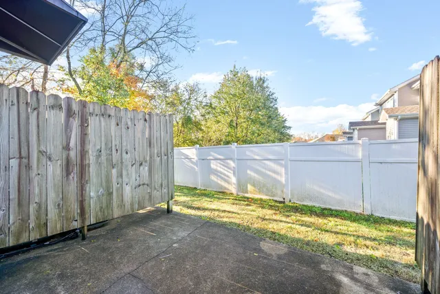 a view of a backyard with wooden fence