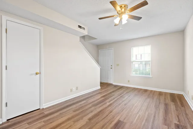 wooden floor in an empty room with a window