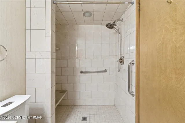 a bathroom with a toilet and shower