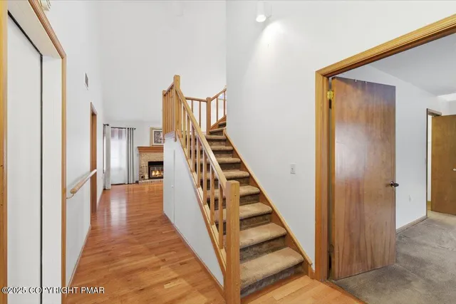 a view of a hallway with wooden floor and entryway