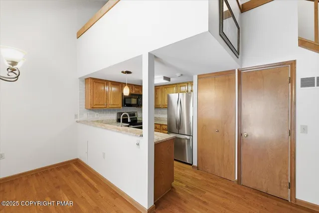 a view of a kitchen from the hallway