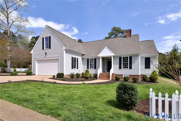 a front view of house with yard and outdoor seating