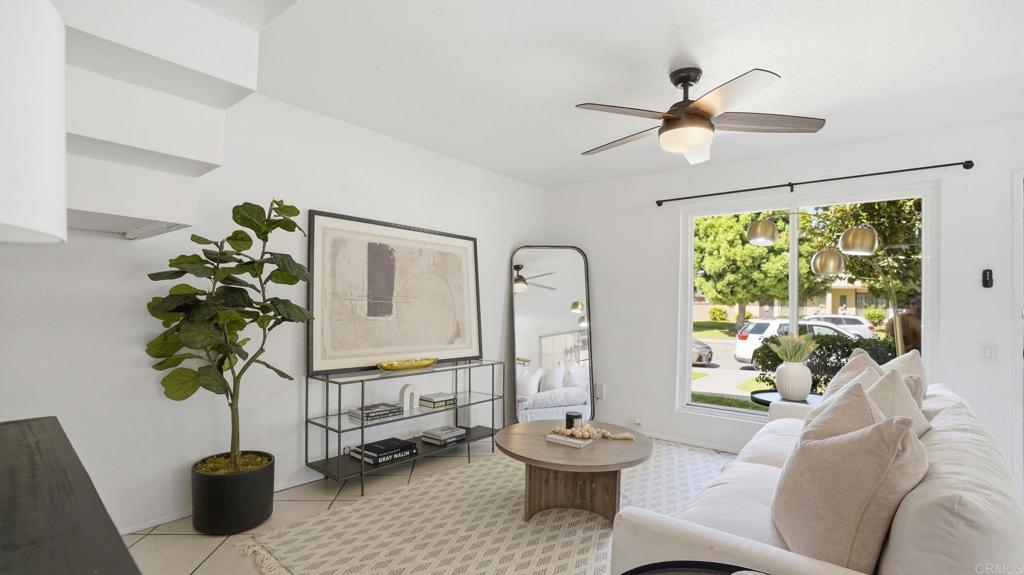 a living room with furniture potted plant and a window