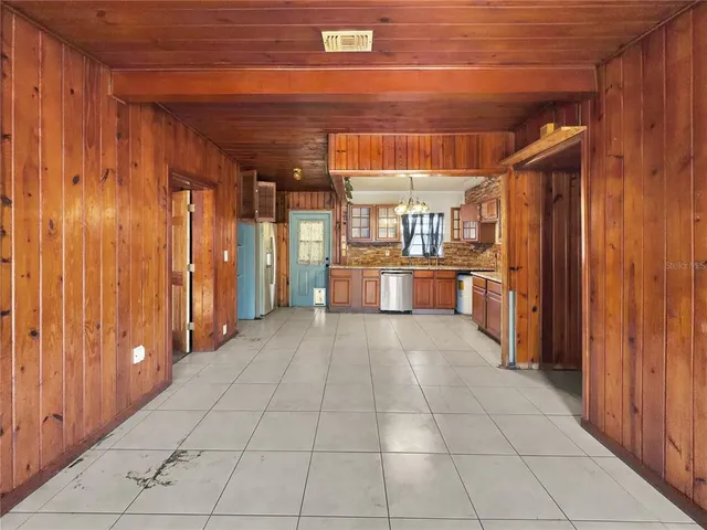 a view of a hallway with wooden walls