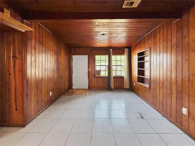 a view of a hallway with wooden shelves
