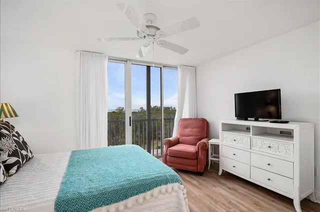 a bedroom with furniture and a flat screen tv