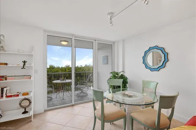 a dining room with furniture and a potted plant