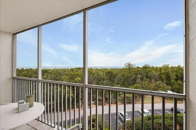 a view of a balcony with yard