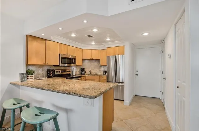 a view of a kitchen with a sink stainless steel appliances and cabinets