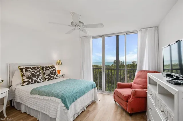 a bedroom with a bed and glass window