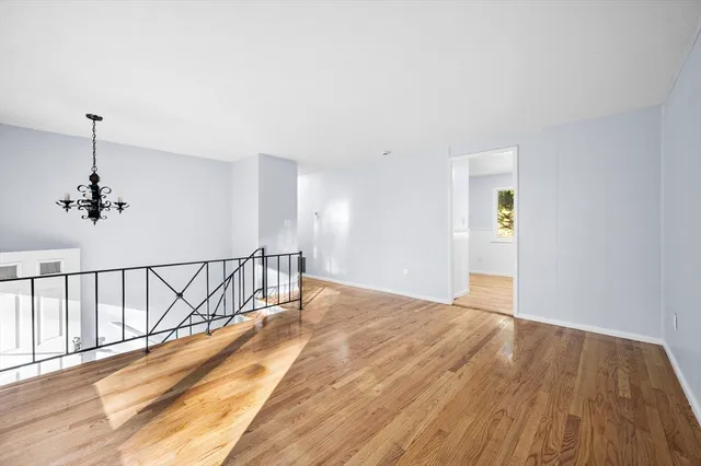 a view of a room with wooden floor