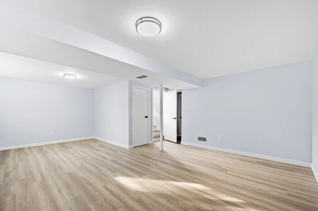 a view of room with wooden floor