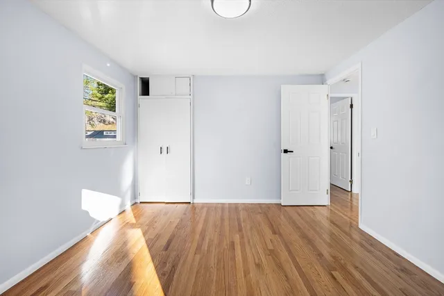 a view of room with wooden floor and white walls