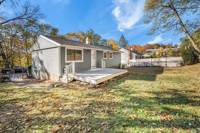 a view of a house with a yard and sitting area