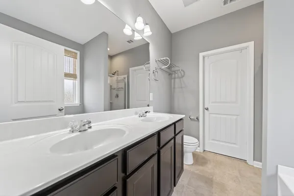 a bathroom with a sink double vanity and a mirror