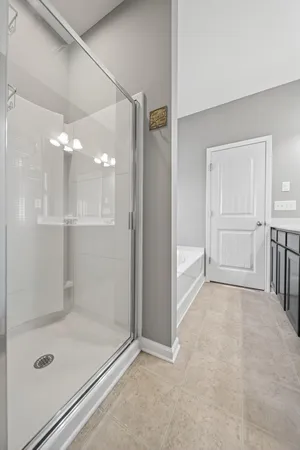 a bathroom with a glass shower door and a sink