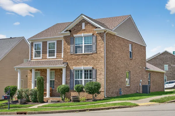 a front view of a house with a yard