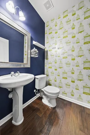 a bathroom with a sink a toilet and shower curtain